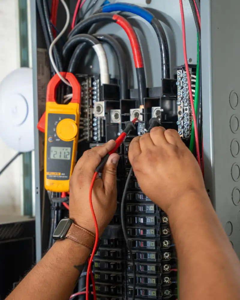 Commercial electrical maintenance Commercial electrical maintenance technician inspecting panel in Texas